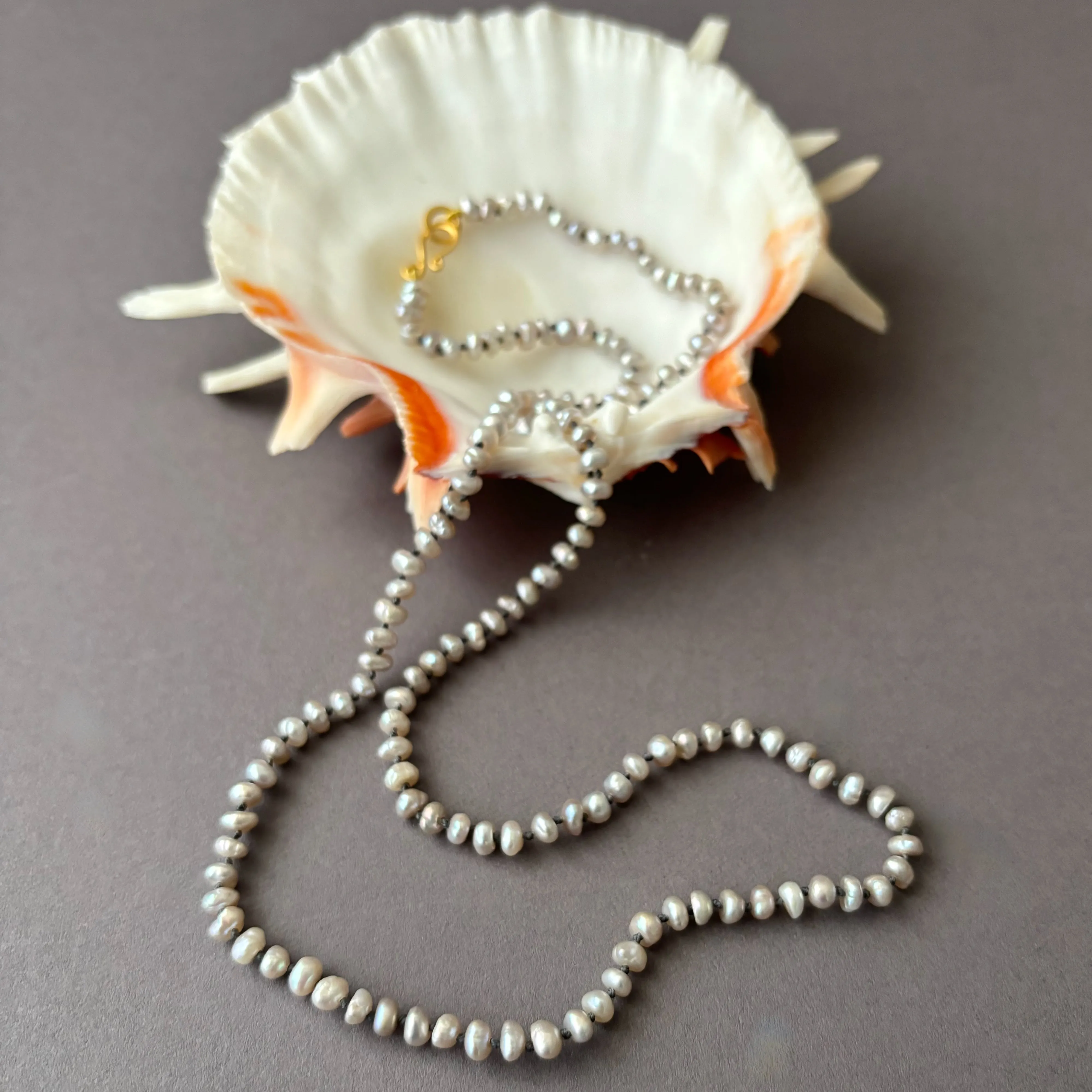 little silver fresh water pearls on deep grey knots necklace
